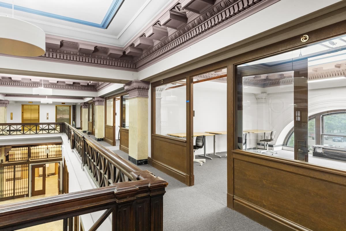The Therm mezzanine with glass-front private offices in a historic St. Louis building